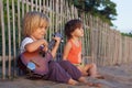 Little children have fun on sunset tropical beach. Royalty Free Stock Photo