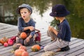 Little children paint small Halloween pumpkins