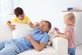 Little children painting their father`s face while he sleeping Royalty Free Stock Photo