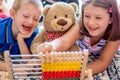 Little children playing with abacus at home. Concept of learning to count Royalty Free Stock Photo