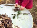 Little children playing, expolring and gardening in the garden with soil, leaves, nuts, sticks, plants, seeds during a school Royalty Free Stock Photo