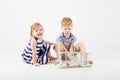 Little Children playing with paper toy airplane sitting on the f Royalty Free Stock Photo