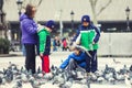 Little children playing with pigeons. Kids in Barcelona, Spain