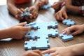 Little children playing with puzzle at table Royalty Free Stock Photo