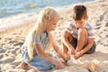 Little children playing with sea shells on beach Royalty Free Stock Photo