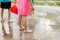 Little children playing at splash pad in the park. Playground with fountain for kids. Summer fun Royalty Free Stock Photo