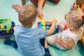 little children playing with toys in the nursery, indoor kindergarten concept Royalty Free Stock Photo