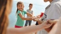 Cute little children playing tug of war game near river on sunny day Royalty Free Stock Photo