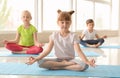 Little children practicing yoga indoors