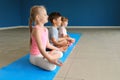 Little children practicing yoga indoors