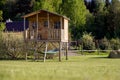 Little children`s tree house with a hammock in the garden on a sunny summer day Royalty Free Stock Photo