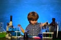 Little children at school lesson. Happy smiling pupil drawing at the desk. Happy little scientist making experiment with Royalty Free Stock Photo