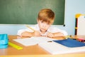 Little children at school lesson. Happy student writing in notebook in school classroom. Back to school concept Royalty Free Stock Photo