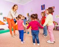 Little children and teacher roundelay on lesson