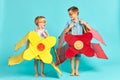 Little children in toy airplane against blue background Royalty Free Stock Photo