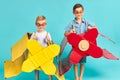 Little children in toy airplane against blue background Royalty Free Stock Photo