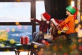 Little children waiting for Santa Claus near window. Christmas holiday