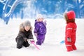 Little children in winter clothes having fun in park at the snowy winter day Royalty Free Stock Photo