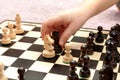 Little childs hand moving a rook chess piece on a chessboard, closeup. Clever anonymous child making a move in a game of chess Royalty Free Stock Photo