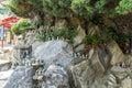 Little chinese priest stone sculptures in the garden of Haedong Yonggungsa Temple Royalty Free Stock Photo