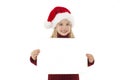 Little Christmas girl presenting. Adorable little girl holding blank paper.