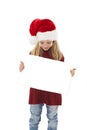 Little Christmas girl presenting. Adorable little girl holding a blank paper.