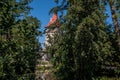 Little church tower near the dirty brown river Royalty Free Stock Photo