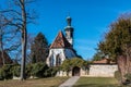 Little church with a white wall and a brown door Royalty Free Stock Photo