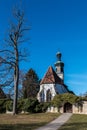 Little church with a white wall and a brown door Royalty Free Stock Photo