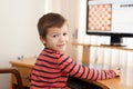 Little clever boy playing chess online
