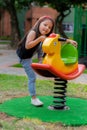 Little colombian girl plays in the park attractions in her backyard Royalty Free Stock Photo