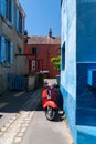 Little colorful alley with vintage scooter in Reze Trentemoult village France Royalty Free Stock Photo