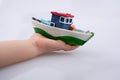Little colorful model boat in hand Royalty Free Stock Photo