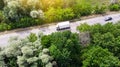 Little commercial lorry driving by the highway between green forest Royalty Free Stock Photo