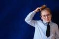 Little confused schoolgirl scratching head Royalty Free Stock Photo