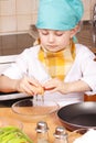 Little cook breaking egg Royalty Free Stock Photo