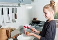 Little cook girl breaks eggs in a deep dish