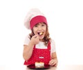 Little cook girl eat cake