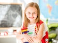 Little counting on the colourful abacus in the school classroom