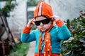 Little country boy in funny clothes and dark glasses Royalty Free Stock Photo