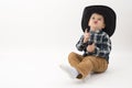 Little cowboy with black hat isolated on white Royalty Free Stock Photo