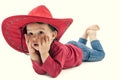 Little cowgirl in a red hat posing on a white Royalty Free Stock Photo