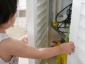 Little curious Asian baby girl`s hands open a cabinet of daddy`s mechanic tools