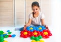 Little curious girl lays plastic puzzles