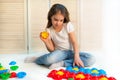 Little curious girl lays plastic puzzles