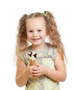 Little curly girl eating ice cream in studio