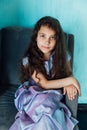 Little curly haired girl in purple dress