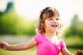 Little curly happy girl running portrait