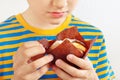 Little cut boy with a appetizing apple muffin on white background close up Royalty Free Stock Photo