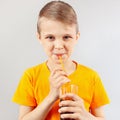 Little cut boy drinking fresh cola through a straw Royalty Free Stock Photo